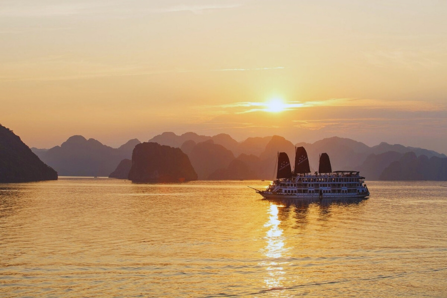 Luxury Halong Bay Cruise sailing at golden sunset with Auasia Travel Vietnam